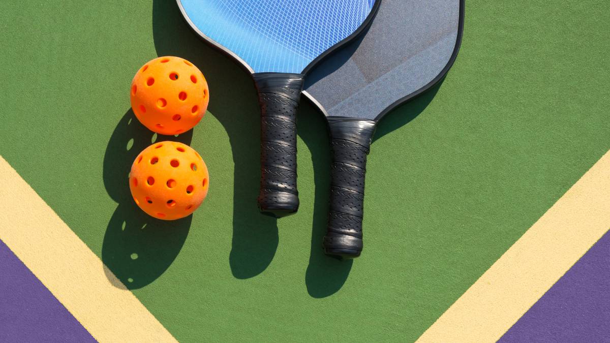 pickleball court with paddles and balls